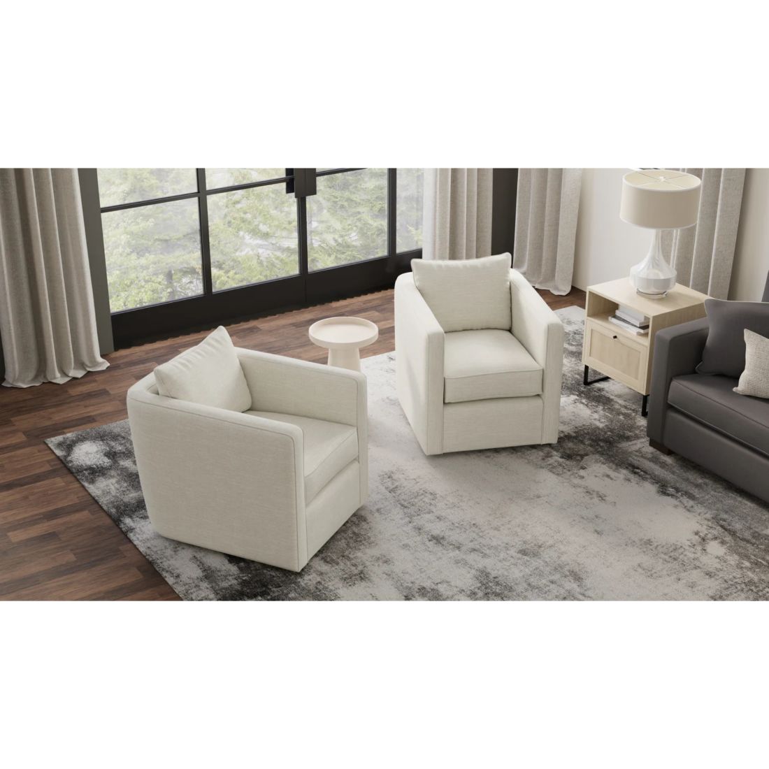 Modern living room with white armchairs, a gray sofa, and a small table.