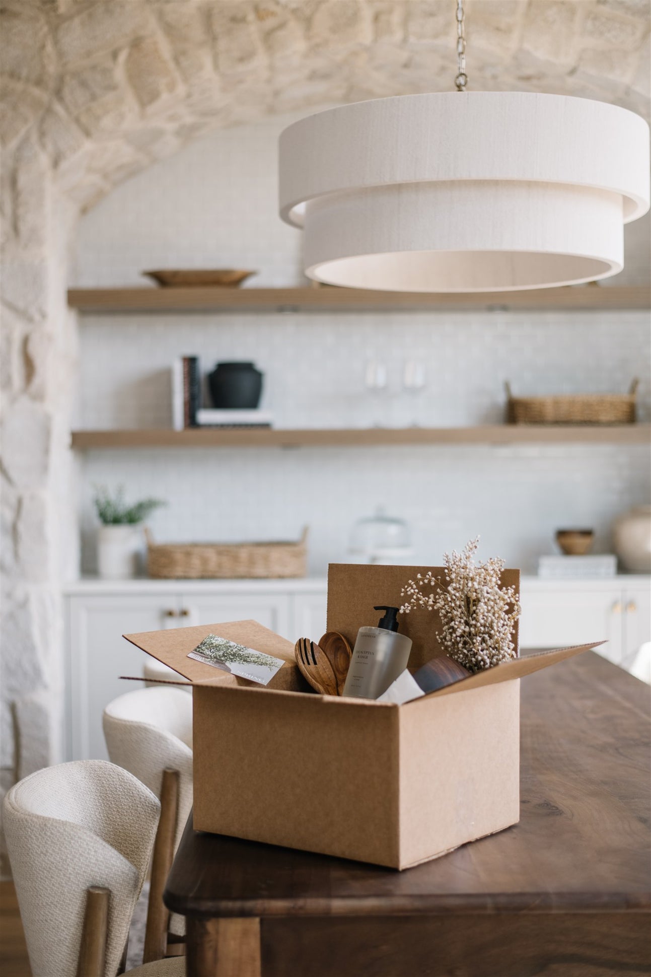 Cardboard box on a wooden table with a kitchen in the background